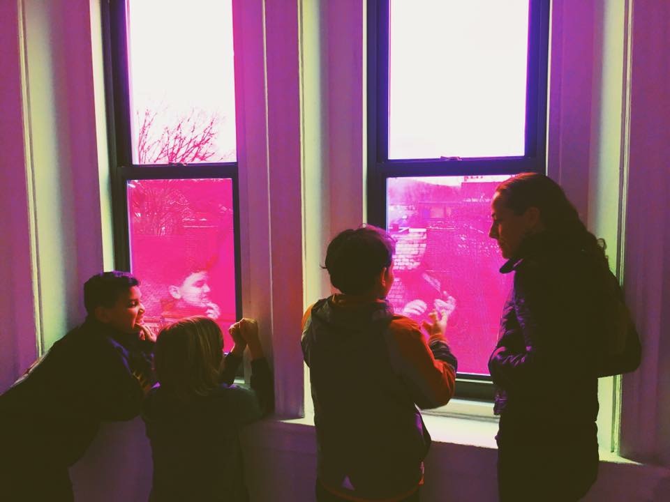 Students with Teresa Duff looking out of the window in Kevin Clancy's installation