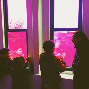Students with Teresa Duff looking out of the window in Kevin Clancy's installation