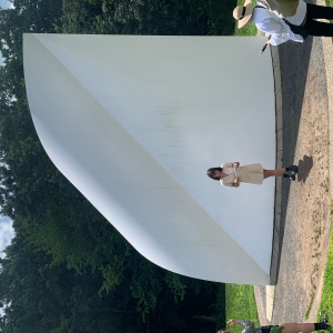 A person stands in front of a large extra 